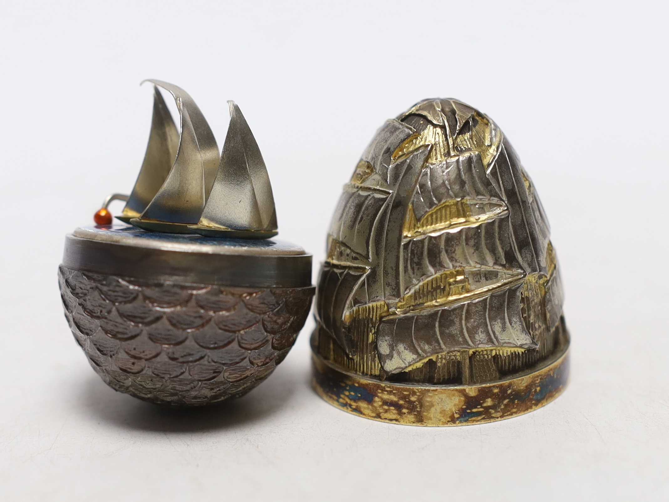 An Elizabeth II parcel gilt silver and enamel surprise egg, by Stuart Devlin, London, 1989, numbered 20, opening to reveal sailing yachts, 6x6mm.